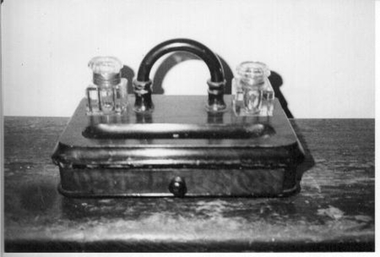  Wooden ink well stand with two glass ink bottles with lids.