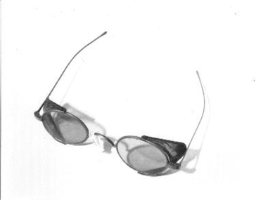  Thin wire framed spectacles with dark tinted lenses. 