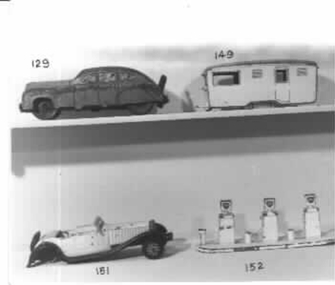 Yellow painted metal toy caravan with orange roof. 