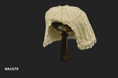 Cream silk crochet baby bonnet lined with cream silk. 