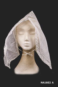 Front view of cap of stiffened machined lace with two pleated 'wings' of stiffened and pleated chiffon on either side.