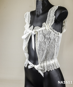 Fine white lace camisole tied with white satin ribbons threaded through eyelets at neck and waist.  