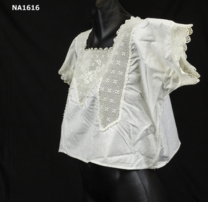 White cotton bust bodice with cream silk crochet lace on square neckline finishing in triangle point and two deep points.