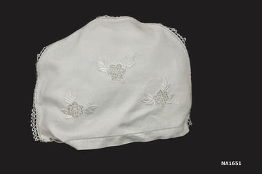 White tea pot cover - semi-circle in shape. hand made tatting and drawthread edging.
