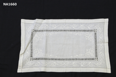 White tray cloth with white embroidery and draw thread inner border.
