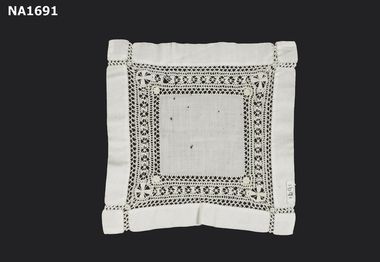 Square white doyley with wide inner border of drawn thread embroidery