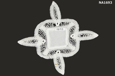 Small white doyley with four points.