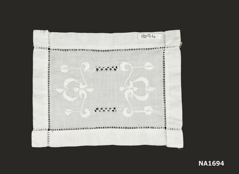 n  Square white cotton doyley with white embroidery and drawn thread work. 