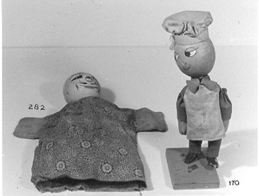 Chef doll on wooden stand. 