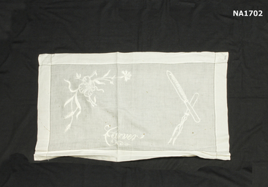 White cotton cloth embroidered with the word 'carver' and carving fork and knife