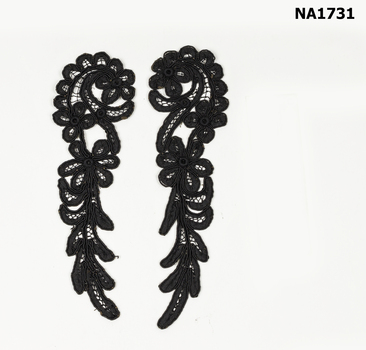 Two pieces of black battenberg lace in spiral design.