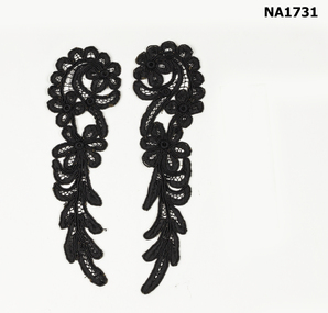 Two pieces of black battenberg lace in spiral design.
