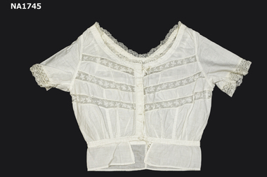 Short sleeve white cotton camisole with cotton lace trim on neck and sleeve edge.