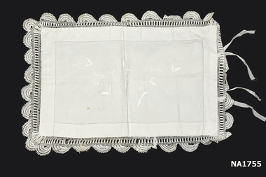 White cotton pillow case with deep crochet edging with white embroidery in centre. 