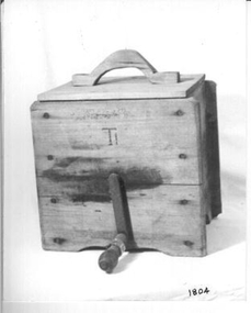 Large lidded wooden box with metal turning handle on outside.  