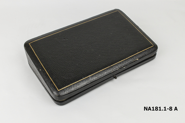 The seven items are enclosed in a velvet lined leather case.