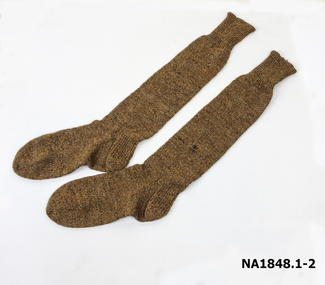 Pair of long brown hand knitted socks.