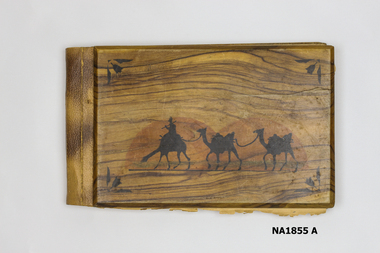 Woode covered book with illustration of three camels on front. 