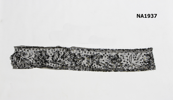 Piece black net heavily decorated 