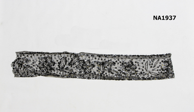 Piece black net heavily decorated 