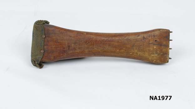 Wide wooden piece padded at one end 