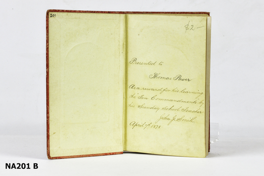 Red hard cover book with picture of kneeling boy on front. 