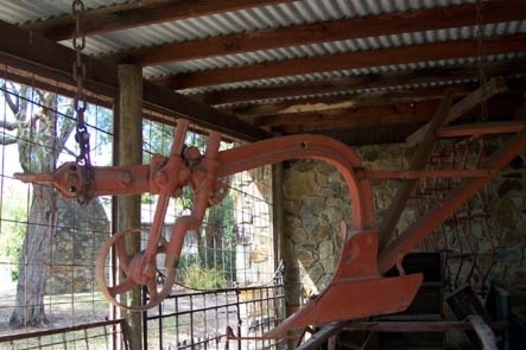 Single farrow plough or spring tooth orchard harrow with wooden handles.