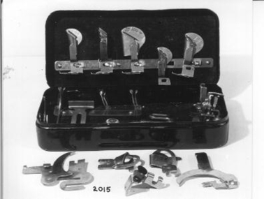 A tin holding an assortment of attachments
