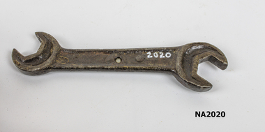 Metal spanner with half hexagonal shapes at either end