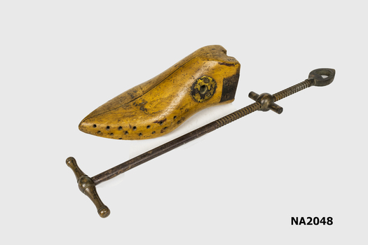 Wooden shoes insert with long metal shaft for stretching. 