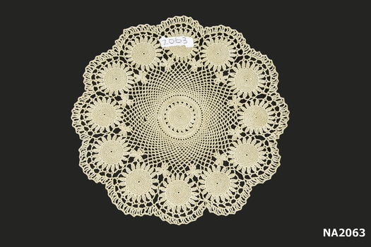 Round ecru crochet doyley.