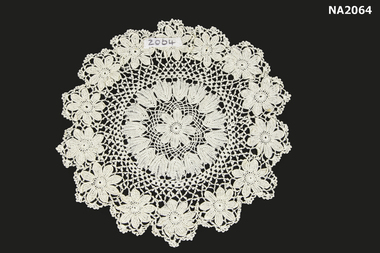 Round white cotton crocheted doyley.