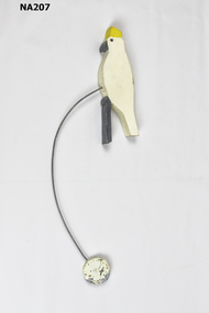 Wooden cockatoo on wire