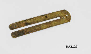 Metal slide with two wide flat prongs.