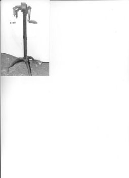 Long thin shaft standing on a three legged round base.
