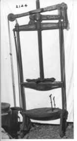 Very large green metal cheese press. 
