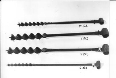 Thick metal shaft with wide corkscrew ending in a point at one end. 