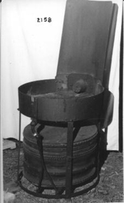 Circular metal stand with leather bellows underneath.