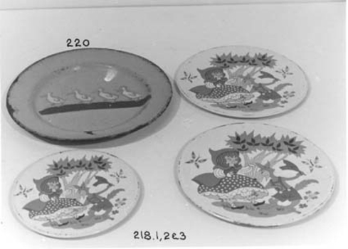 Two plates and one saucer of a child's tea set.