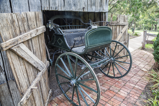 Two seater, four wheel buggy painted green with cream trim.