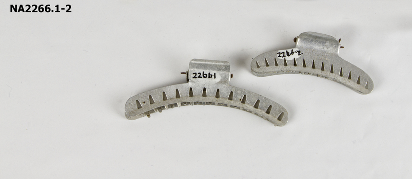 Metal hair curlers with interlocking teeth.