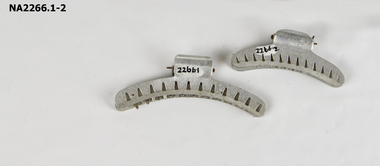 Metal hair curlers with interlocking teeth.