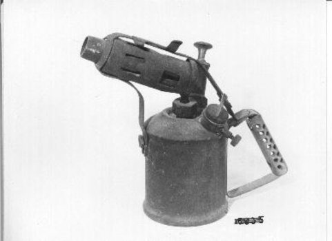 Round metal cylinder with handle. 