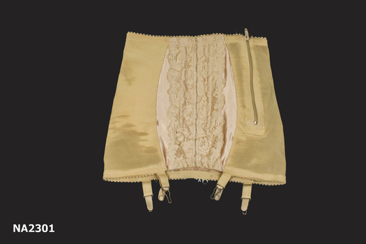 Flesh coloured step-in girdle, satin and lace in front with zip at side, satin panel at back. 