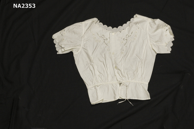 White cotton camisole with small pearl buttons.