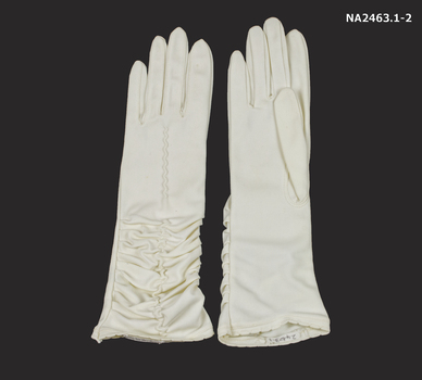 Pair cream mid length gloves.  