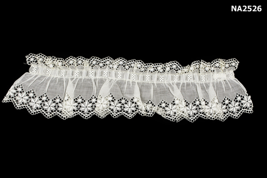 Broderie anglais frill top with deeper frill at bottom.