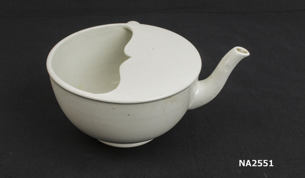 Large white ceramic feeding cup with spout and one handle.