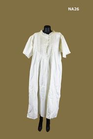 Cream nightdress, short sleeves, concealed press studs.