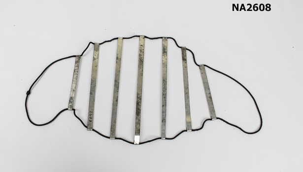 A type of net made from a large loop of black elastic with seven steel strips.